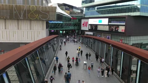 People walking on footbridge spanning train station Stock-Footage 161285133