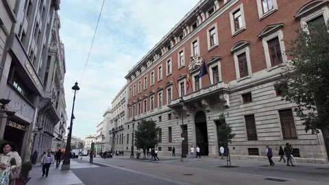 People walking in Front of a Big Old Brick Building in Spain Stock Footage 293631133