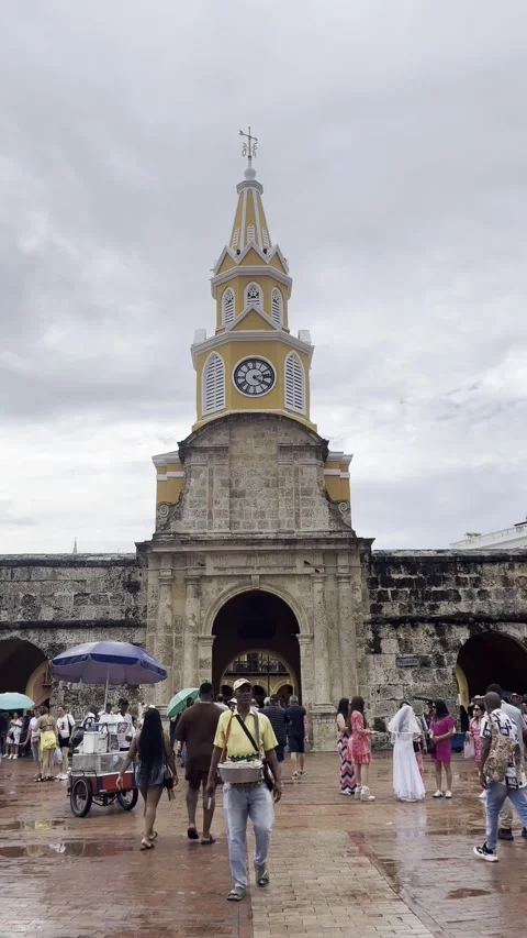 People walking in front of the clock tower in old town Cartagena, Colombia Stock Footage 292565068