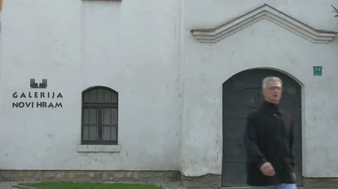 People walking in front of the New Temple Gallery in Sarajevo Stock Footage 59857853