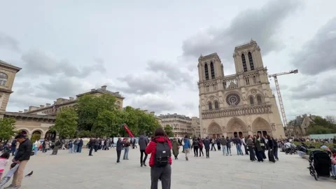 People walking in front of the Notre Dame Cathedral in Paris Stock Footage 336008221