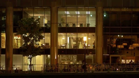 People walking in front of office building at night in Fukuoka city Stock Footage 80174732