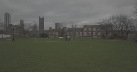 People walking in the green ground on cloudy day in financial hub Stock-Footage 170924401