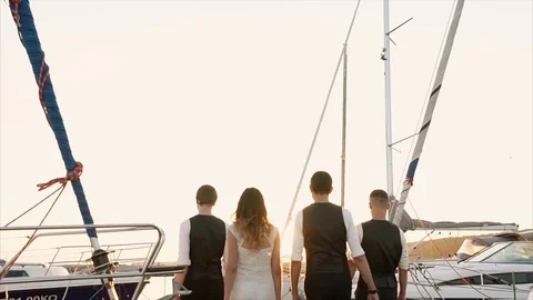 People walking in harbour at sunset Stock Footage