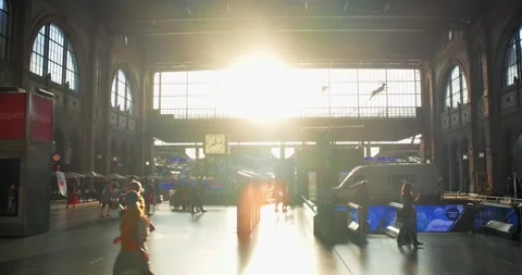 People walking inside main station atrium hall at sunset Stock Footage 314782712