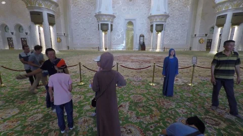 People walking inside the Sheikh Zayed Grand Mosque in Abu Dhabi Video stock 91933329