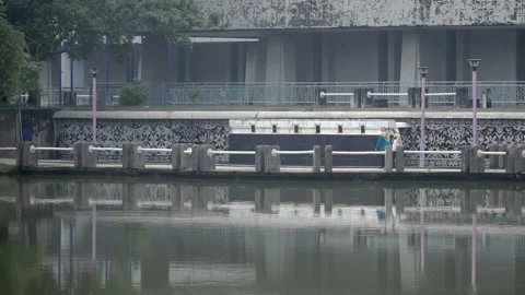 People walking &amp; jogging at lake Stock Footage 157376949