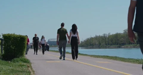 People walking on lakeside path at Jarun Lake 库存影片 332511091