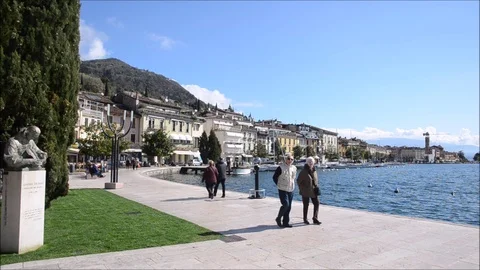 People walking on the lakeside in salò Stock Footage