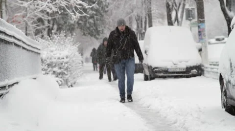 People Walking  In Line On A Narrow Path In Snow, City Street, Blizzard, Winter Video stock 45536997