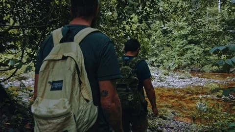 People walking in a line on a rainforest path during a hike across the lush v Stock Footage 97929315