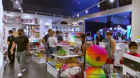 People Walking, Looking In Dave &amp; Busters Arcade Prize Room Wearing Masks Видео 237675589