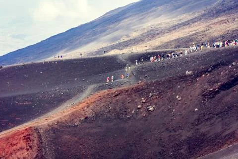 People walking on Mount Etna, active volcano on the east coast of Sicily, Ita Stock Photos