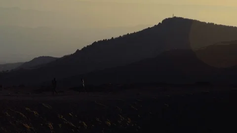 People walking on Mount Etna at Sunset Stock Footage 88562910