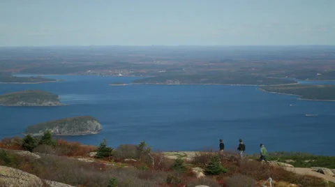 People walking up mountain overlooking the ocean Stock Footage 28655004