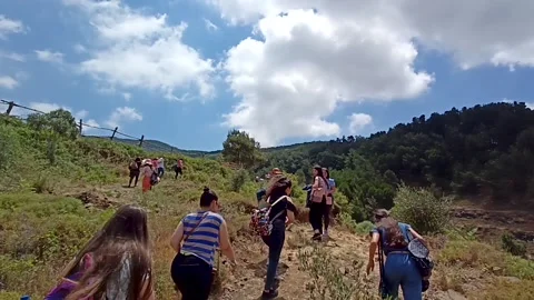 People walking on a mountain pathway Stock Footage 194376463