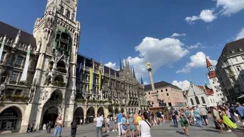 People walking by Munich clock tower Rathaus-Glockenspiel in summerUntitled.. Video stock 249352228