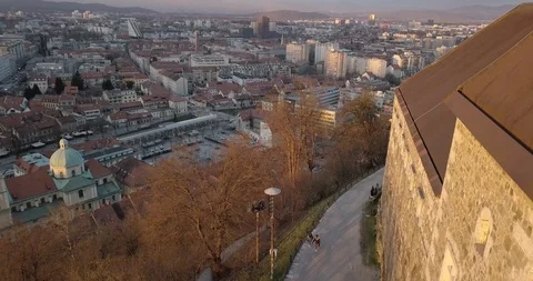 People walking near castle with city in the background Stock Footage