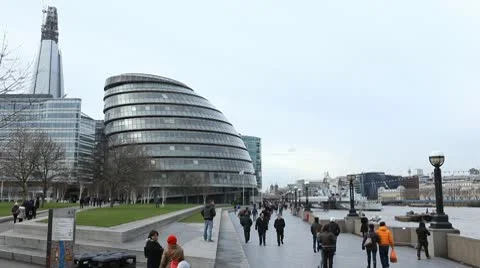 People walking near City Hall, Greater London Authority, Mayor, Thames River Stock Footage