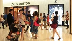 BANGKOK - MARCH 17, 2016 : Unidentified People Stand In Queue To Get To A  Louis Vuitton Store In The Siam Paragon Shopping Mall. For Years 2006–2012  LV Was Named The Worlds