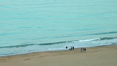 People Walking on the Ocean Beach in Spring Stock Footage 309151905