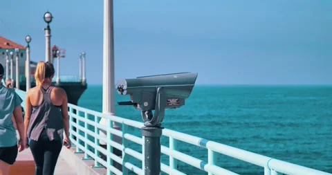 People walking by ocean view on pier with binoculars Stock Footage 339519744