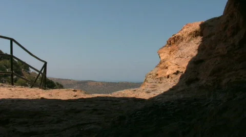 People walking in the opening of a cave Stock Footage 534001
