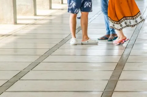 People walking over the floor with a pattern. Beautiful legs. Stock Photos