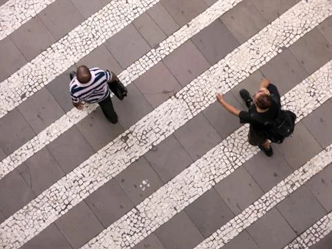 People walking over pattern sidewalk - birds eye Stock Photos