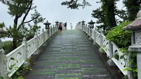 People walking over seonim bridge on jeju island in south korea Stock Footage 343066971