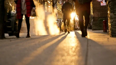 People walking over steam grating with bright sun in New York City 스톡 동영상 99365657