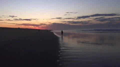 People walking at a pacific beach Stock Footage 133451754