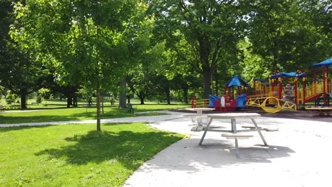 People Walking In Park In Empty Childrens Playground Fearful Of Virus Stockbeeldmateriaal 165369697