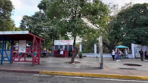 People walking at Parque del Oeste Ali Primera, street view from Catia, city Stock-Footage 306355672