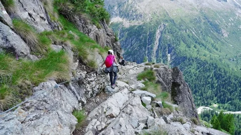 People walking on the path of the upper valley of genoa in trentino Stock Footage 246625838