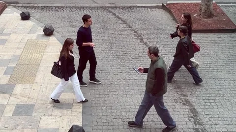 People walking on pavement tiles to work Stock Footage 308923544
