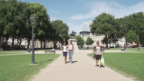 People walking queens square bristol sunny Stock Footage 69752500