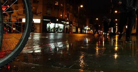 People walking in rainy evening 스톡 동영상 99559061