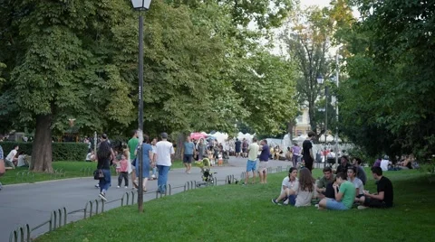 People walking rest in park during urban cultural festival Stock Footage 66472092