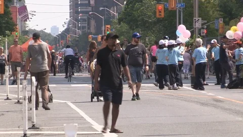 People walking riding bikes and dancing in the streets Stock Footage 79046784