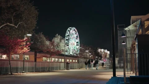 People walking on river front next to train Stock Footage 293947804
