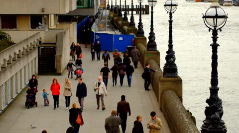 People walking on riverside pavement Stock Footage 36596797