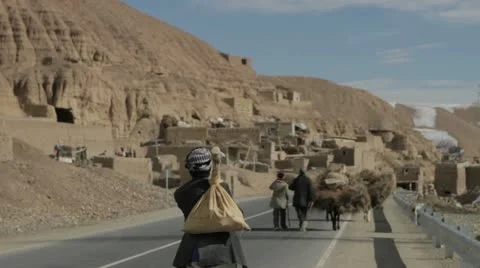 People walking on a road, Afghanistan Stock Footage