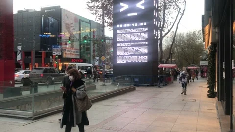 People walking on the road and large advertising television Stock Footage 145480903