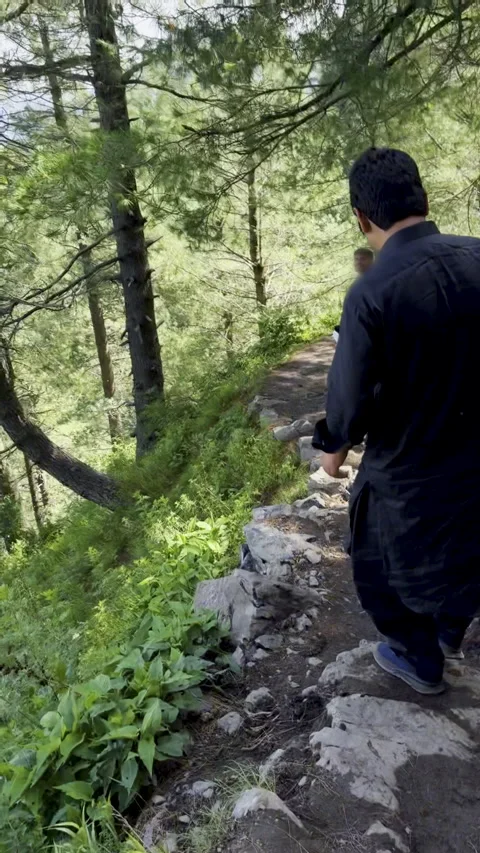 People Walking on a Rocky Mountain Path in Abbottabad Stock Footage 309344957