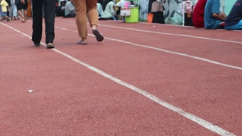 People Walking Running Barefoot Jogging Track Stock Footage 243045719