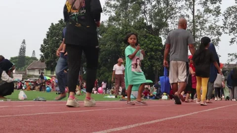People walking, running, playing, gathering with family on Alun-Alun Cibodas Stock Footage 242854668
