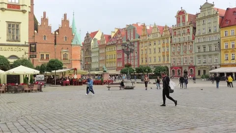 People walking in the Rynek square of the Polish city of Wroclaw Stock Footage 141837101