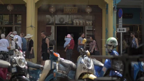 People Walking with Scooter in Foreground Stock Footage 85516503