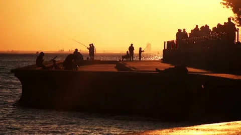 People walking at the seaside in sunset Stock Footage 68708327